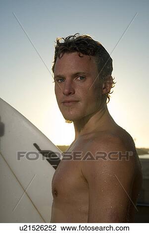 Stock Image - Young male surfer. Fotosearch