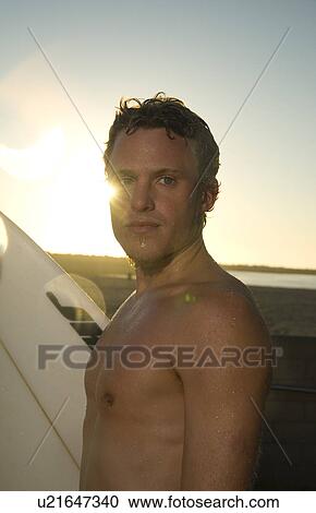 Young male surfer View Large Photo Image Stock Image - Young male surfer. Fotosearch