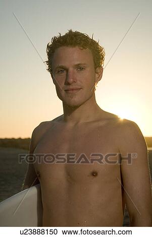 Young male surfer View Large Photo Image Stock Image - Young male surfer. Fotosearch
