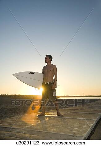 Young male surfer View Large Photo Image Stock Image - Young male surfer. Fotosearch