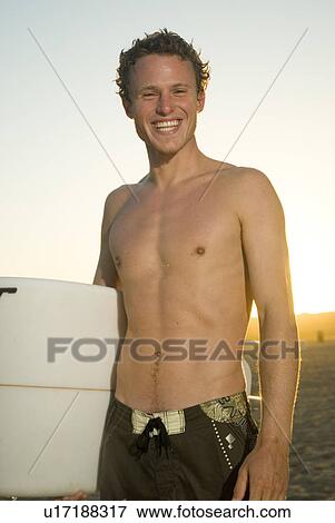 Stock Photo - Young male surfer. Fotosearch