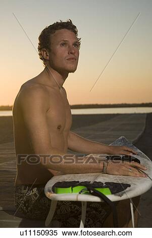 Stock Photography - Young male surfer. Fotosearch