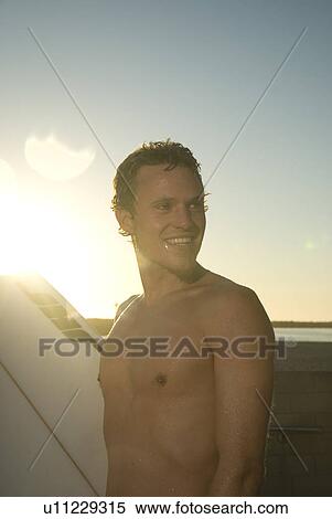 Stock Photography - Young male surfer. Fotosearch