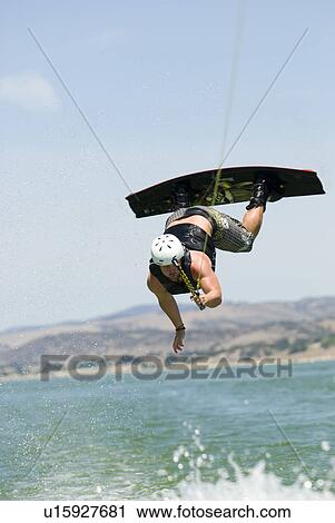 Young male wake boarding in the air View Large Photo Image Stock Image - Young male wake boarding in the air. Fotosearch