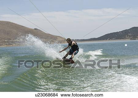 Young male wake boarding View Large Photo Image Picture - Young male wake boarding. Fotosearch