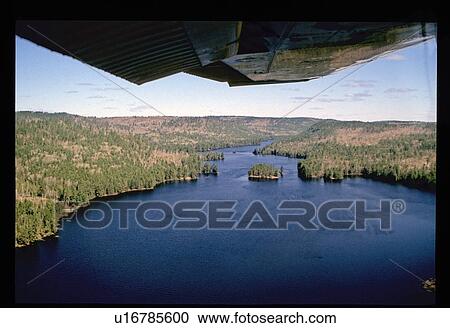 Stock Image - Aerial view of river through forest. Fotosearch