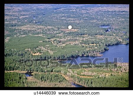 Stock Photo - Aerial view of river through forest. Fotosearch