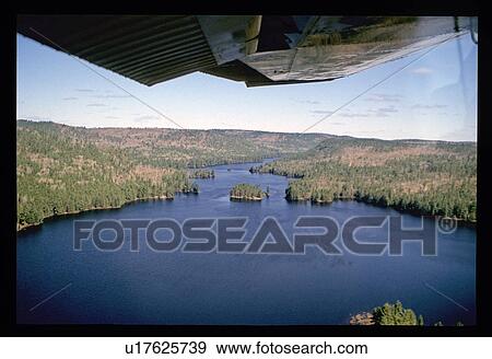 Stock Photo - Aerial view of river through forest. Fotosearch