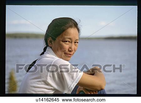 Stock Photography - Asian woman on the shore. Fotosearch