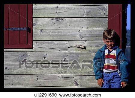 Boy by a barn View Large Photo Image Stock Image - Boy by a barn. Fotosearch