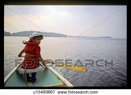 Stock Photo - Boy canoeing. Fotosearch