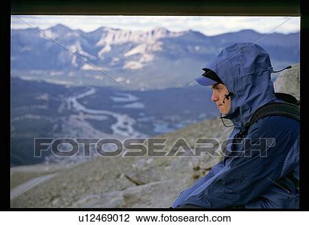 Stock Image - Boy hiking up a mountain. Fotosearch