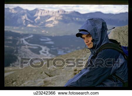 Stock Photograph - Boy hiking up a mountain . Fotosearch