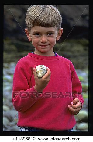 Boy holding stone View Large Photo Image Stock Image - Boy holding stone. Fotosearch