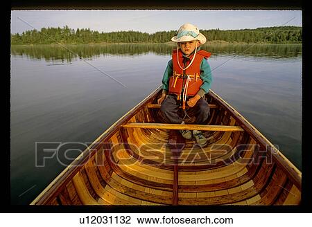 Stock Image - Boy in a canoe. Fotosearch