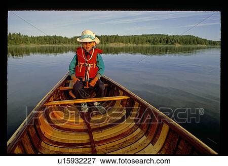 Boy in a canoe View Large Photo Image Stock Photo - Boy in a canoe. Fotosearch
