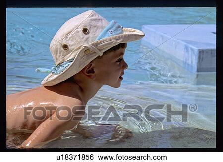 Boy in a pool View Large Photo Image Stock Photograph - Boy in a pool. Fotosearch