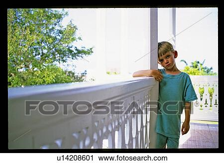 Stock Image - Boy on a porch . Fotosearch