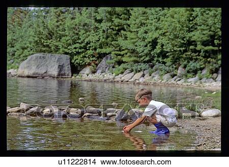 Boy playing in the water View Large Photo Image Picture - Boy playing in the water. Fotosearch