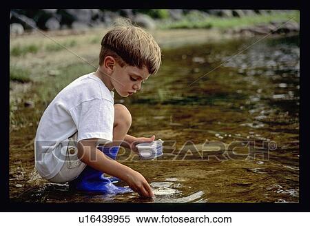 Boy playing in the water View Large Photo Image Stock Photography - Boy playing in the water. Fotosearch