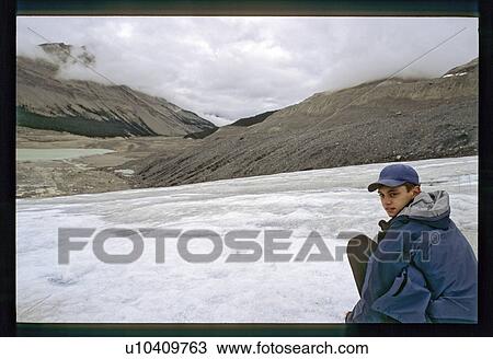 Stock Image - Boy playing on the ice. Fotosearch