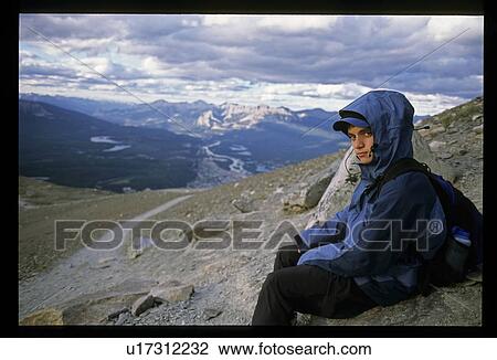 Boy sitting on mountain View Large Photo Image Stock Image - Boy sitting on mountain. Fotosearch