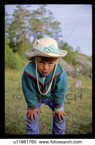 Stock Photography - Boy sticking out his tong . Fotosearch