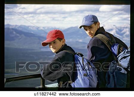 Boys hiking up a mountain View Large Photo Image Stock Image - Boys hiking up a mountain . Fotosearch