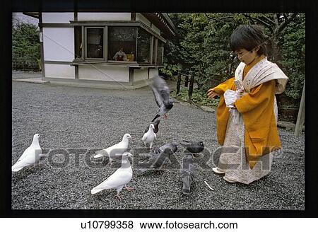 Buddha's child feeding birds View Large Photo Image Stock Photo - Buddha's child feeding birds. Fotosearch