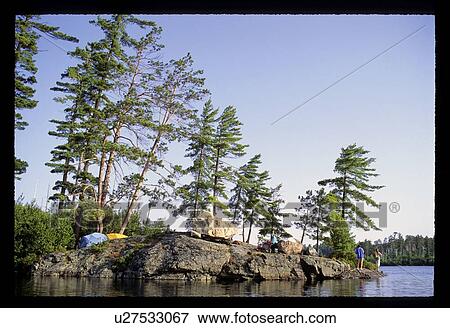 Stock Photo - Camping on a rock. Fotosearch