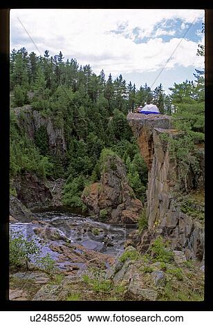 Stock Photography - Camping on a rock. Fotosearch