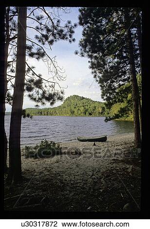 Stock Image - Canoe on a shore. Fotosearch