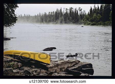 Stock Image - Canoe on the shore. Fotosearch