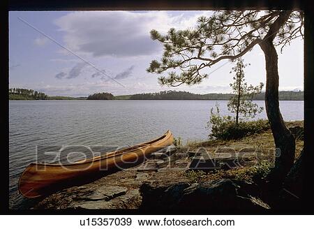 Stock Photo - Canoe on the shoreline. Fotosearch