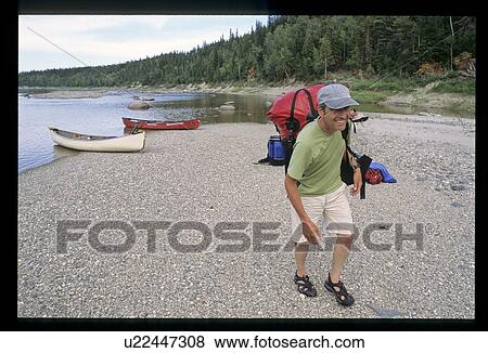Canoe person leaving the water View Large Photo Image Stock Photo - Canoe person leaving the water. Fotosearch