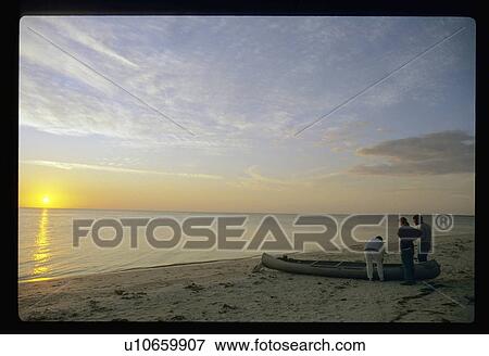 Stock Photo - Canoeing at sunset. Fotosearch