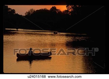 Stock Photo - Canoeing at sunset. Fotosearch