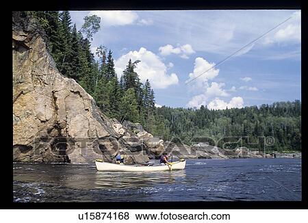 Canoeing by rocks View Large Photo Image Stock Photo - Canoeing by rocks. Fotosearch