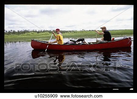 Canoeing down a river View Large Photo Image Stock Photo - Canoeing down a river. Fotosearch