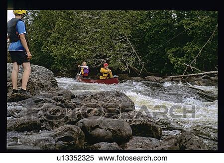 Stock Photography - Canoeing down a river. Fotosearch