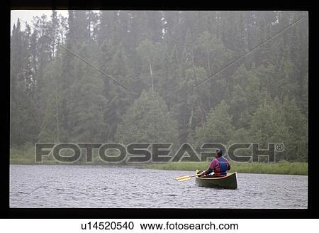 Stock Image - Canoeing in the fog . Fotosearch