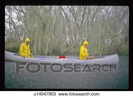 Stock Image - Canoeing in the rain. Fotosearch