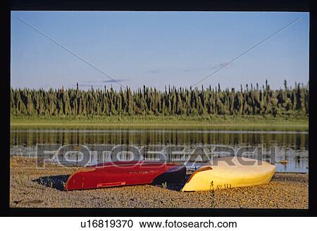 Stock Image - Canoes on the shore. Fotosearch