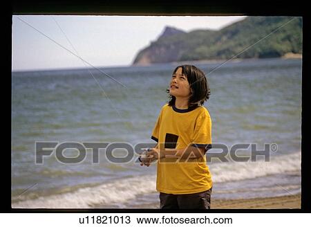 Child flying a kite View Large Photo Image Stock Image - Child flying a kite. Fotosearch