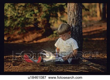 Child reading in the forest View Large Photo Image Stock Photo - Child reading in the forest. Fotosearch