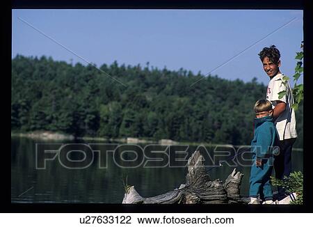 Stock Image - Children by the lake. Fotosearch