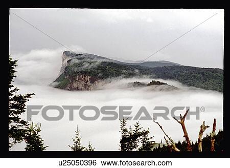 Cliff through the clouds View Large Photo Image Stock Photograph - Cliff through the clouds. Fotosearch