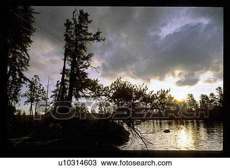 Stock Image - Clouds over a lake. Fotosearch