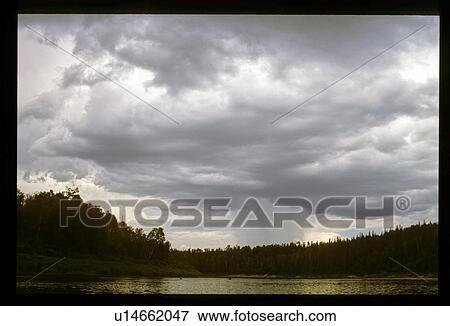 Stock Photo - Clouds over a lake. Fotosearch