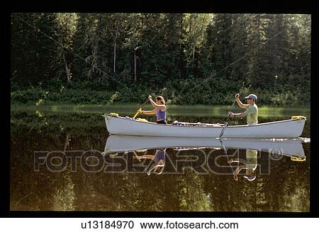 Stock Image - Couple canoeing. Fotosearch